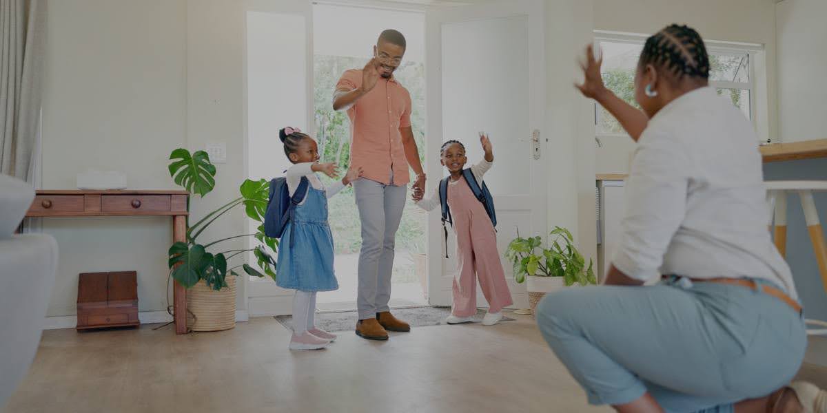 Parent greeting excited children at the doorway during visitation rights NY parenting time exchange, showcasing positive co-parenting relationships